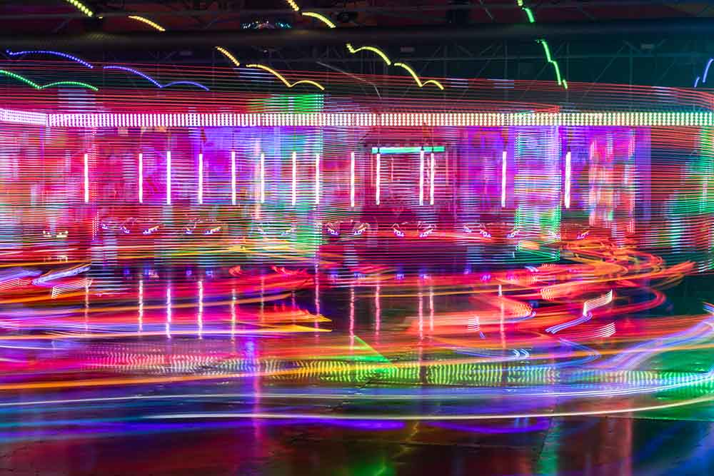 Light trails from a fairground ride at night