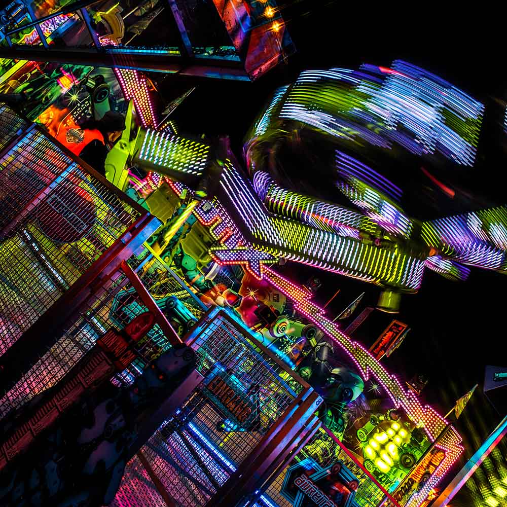 Dynamic ride with colorful LED light trails at night