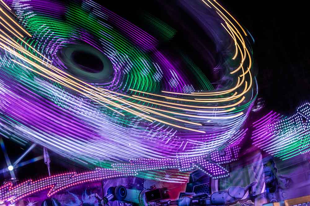 Abstract light trails of a fairground ride at night